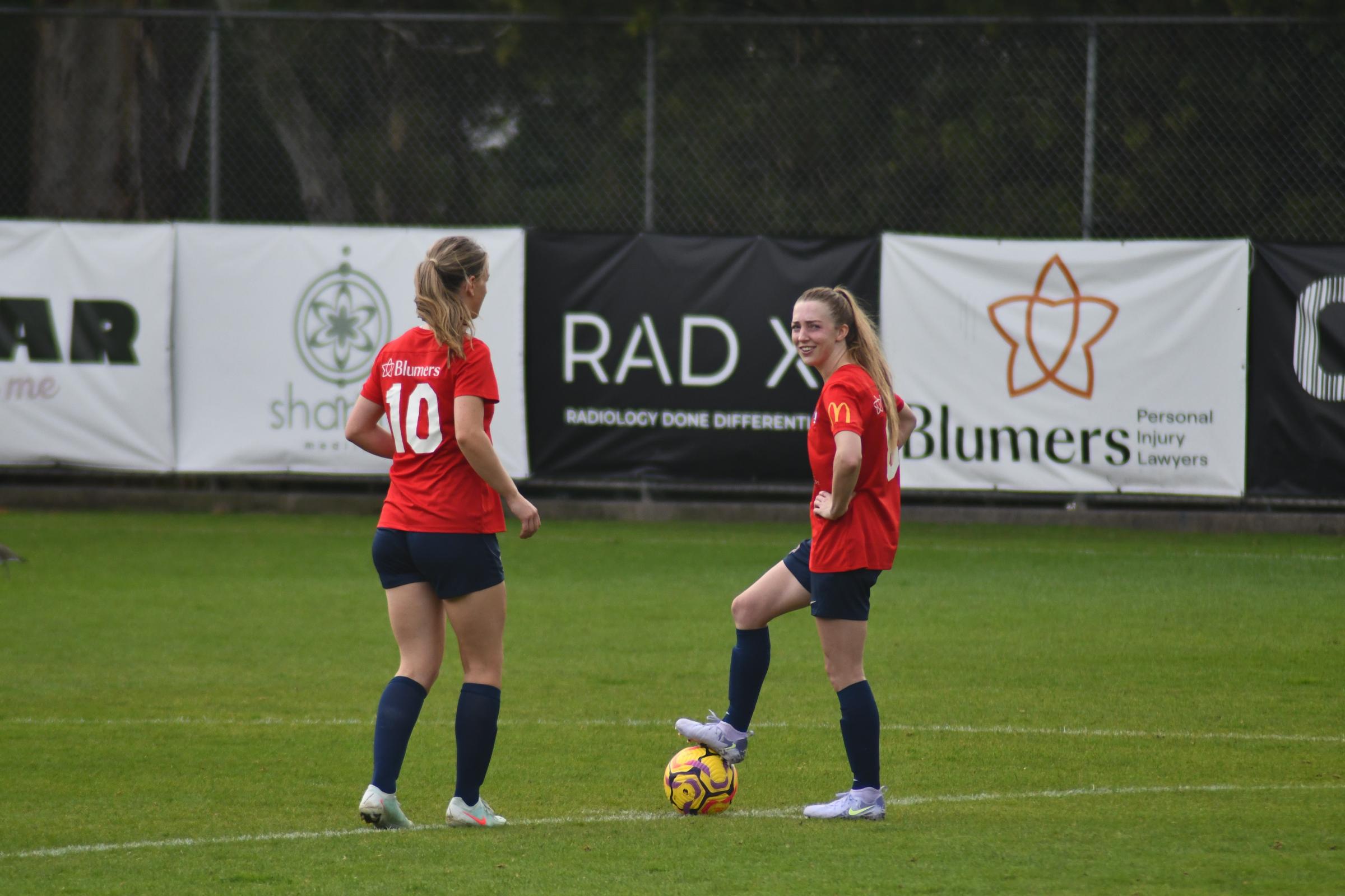 Laura Davis and Jaz White pull on the red shirts for South Hobart.