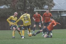 South Hobart goalscorer Sam Berezansky tackles Devonport teammates Kirk Aitken and Raph Reynolds. Picture by SHFC