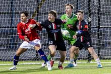 Clarence players heap pressure on Glenorchy keeper Tim Divin. Picture by Lisa Creese